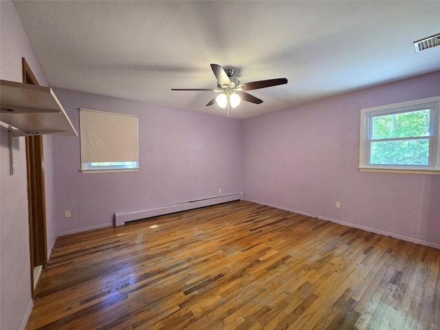 241 Summit Park Rd, Spring Valley, NY 10977 - spare room featuring wood finished floors, baseboard heating, a ceiling fan, and baseboards