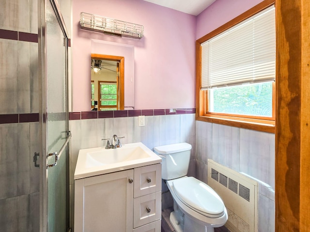 241 Summit Park Rd, Spring Valley, NY 10977 - full bath with radiator heating unit, a shower stall, toilet, vanity, and a wainscoted wall