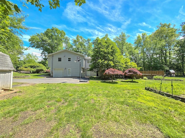 241 Summit Park Rd, Spring Valley, NY 10977 - view of yard with an attached garage and asphalt driveway