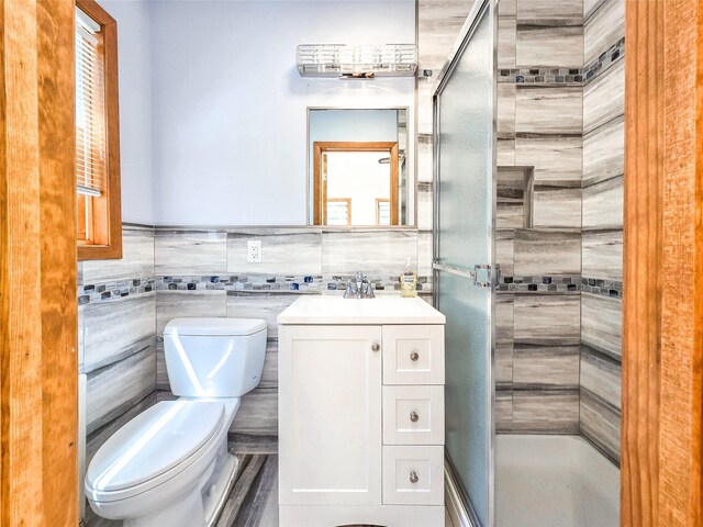 241 Summit Park Rd, Spring Valley, NY 10977 - bathroom with toilet, a shower stall, vanity, and tile walls