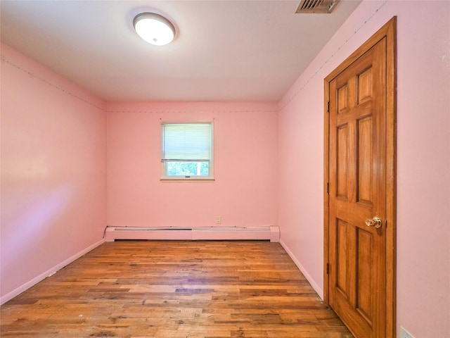 241 Summit Park Rd, Spring Valley, NY 10977 - unfurnished room featuring baseboard heating, wood finished floors, and baseboards