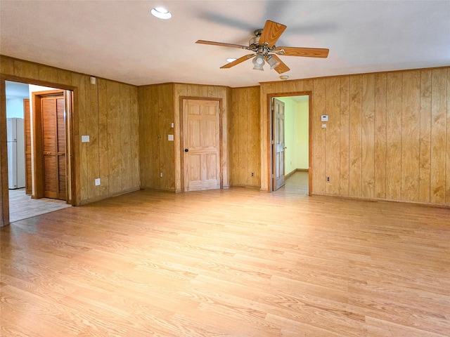 241 Summit Park Rd, Spring Valley, NY 10977 - unfurnished room with light wood-style floors, a ceiling fan, wood walls, and baseboards