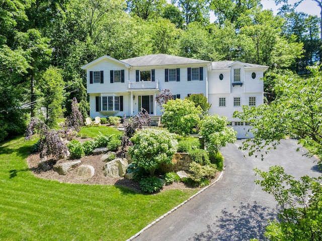 70A Davis Rd, Port Washington, NY 11050 - view of front of home with asphalt driveway, a front yard, and view of wooded area