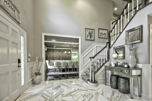 70A Davis Rd, Port Washington, NY 11050 - entrance foyer with a decorative wall, a high ceiling, stairway, marble tiled flooring, and wainscoting