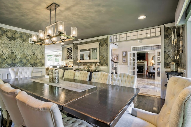 70A Davis Rd, Port Washington, NY 11050 - dining area with ornamental molding, a chandelier, recessed lighting, wainscoting, and a decorative wall