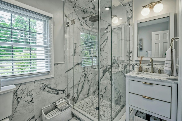 70A Davis Rd, Port Washington, NY 11050 - bathroom featuring vanity, healthy amount of natural light, a marble finish shower, toilet, and tile walls