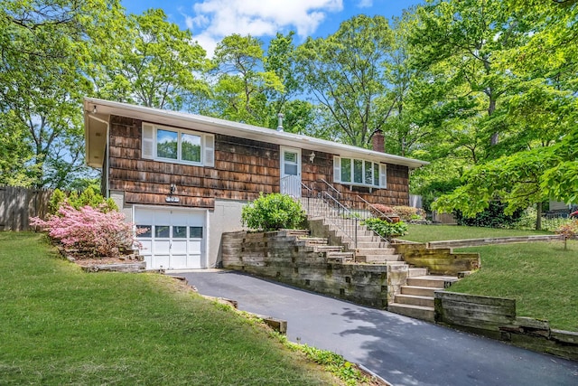 29 Patchogue Rd, Sound Beach, NY 11789 - view of front of house featuring asphalt driveway, an attached garage, a front yard, and a chimney