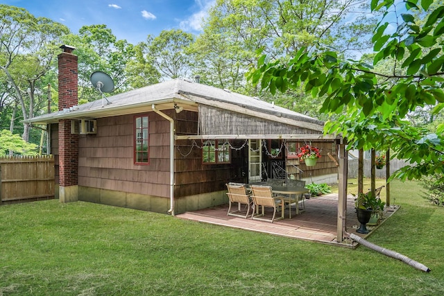 29 Patchogue Rd, Sound Beach, NY 11789 - back of property with a chimney and outdoor dining area