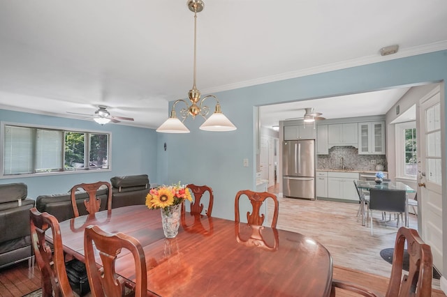 29 Patchogue Rd, Sound Beach, NY 11789 - dining room featuring plenty of natural light, light wood-style floors, a ceiling fan, and ornamental molding