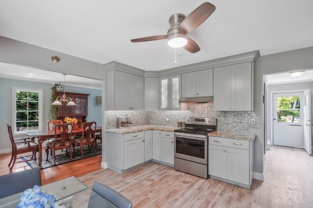 29 Patchogue Rd, Sound Beach, NY 11789 - kitchen featuring stainless steel electric range, under cabinet range hood, decorative backsplash, and plenty of natural light