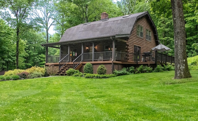 1206 Hollow Rd, Clinton Corners, NY 12514 - log-style house featuring a gambrel roof, a front lawn, log exterior, and roof with shingles