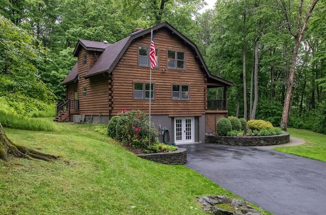1206 Hollow Rd, Clinton Corners, NY 12514 - view of side of home featuring french doors, a lawn, a gambrel roof, asphalt driveway, and log siding
