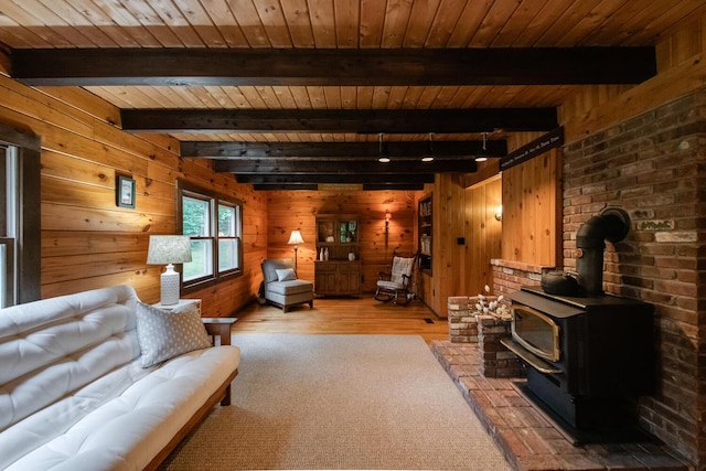 1206 Hollow Rd, Clinton Corners, NY 12514 - living room with wood walls, wooden ceiling with exposed beams, hardwood / wood-style floors, and a wood stove