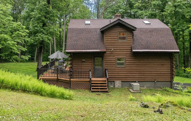 1206 Hollow Rd, Clinton Corners, NY 12514 - back of property with roof with shingles, a wooden deck, a chimney, log siding, and a lawn