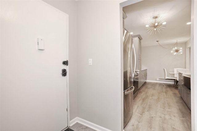 221 Richard Ct, Pomona, NY 10970 - kitchen featuring light wood-style flooring, baseboards, a baseboard radiator, and stainless steel refrigerator