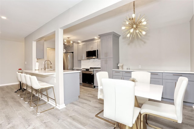 221 Richard Ct, Pomona, NY 10970 - dining space with a chandelier, light wood finished floors, and baseboards