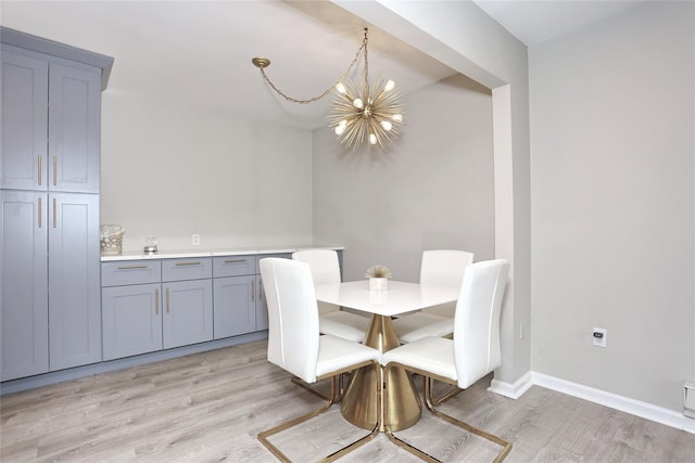 221 Richard Ct, Pomona, NY 10970 - dining room with a chandelier, light wood-style floors, and baseboards