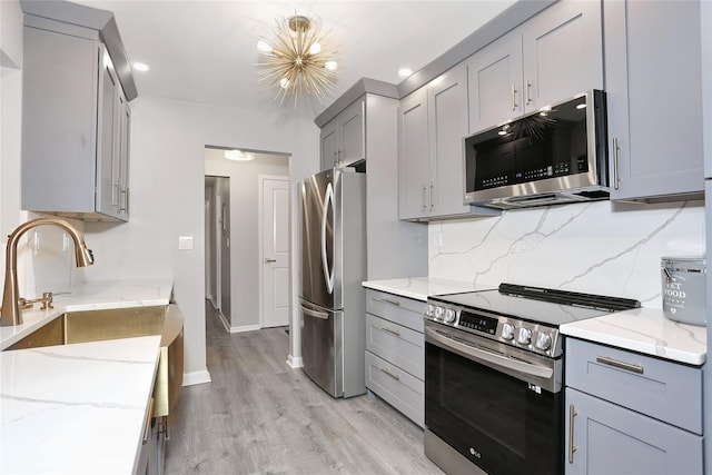 221 Richard Ct, Pomona, NY 10970 - kitchen with appliances with stainless steel finishes, gray cabinets, light stone counters, and recessed lighting