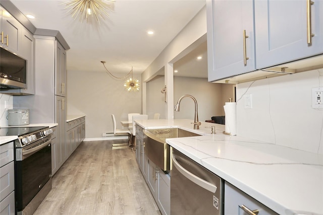 221 Richard Ct, Pomona, NY 10970 - kitchen with appliances with stainless steel finishes, gray cabinets, a sink, light stone counters, and recessed lighting
