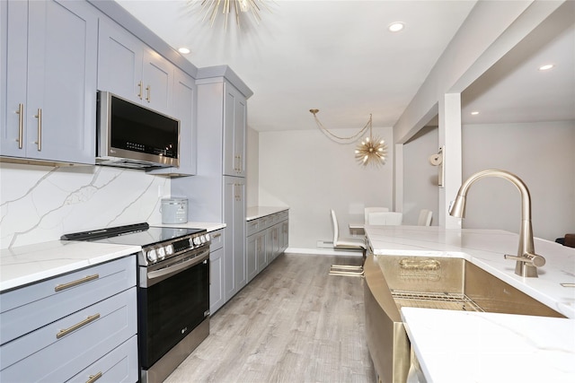 221 Richard Ct, Pomona, NY 10970 - kitchen featuring stainless steel appliances, gray cabinets, light stone countertops, light wood-style flooring, and recessed lighting