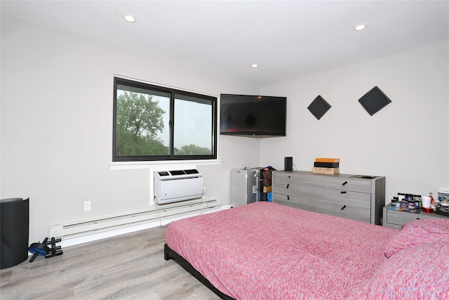 221 Richard Ct, Pomona, NY 10970 - bedroom featuring light wood finished floors, a wall mounted AC, recessed lighting, and a baseboard radiator