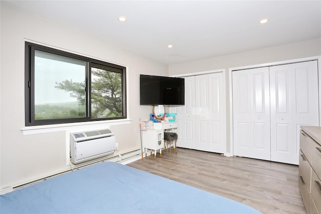 221 Richard Ct, Pomona, NY 10970 - bedroom with two closets, light wood finished floors, a wall unit AC, and recessed lighting