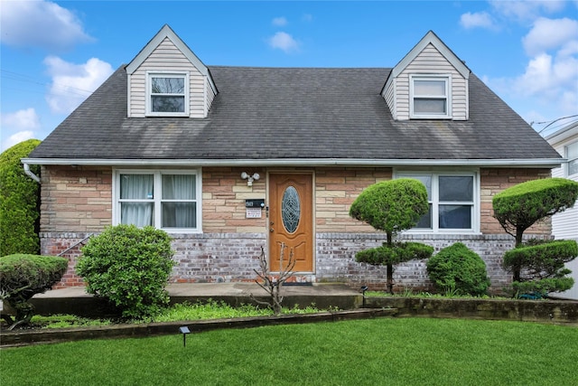 1343 E St, Elmont, NY 11003 - view of front facade featuring a front yard, roof with shingles, and stone siding