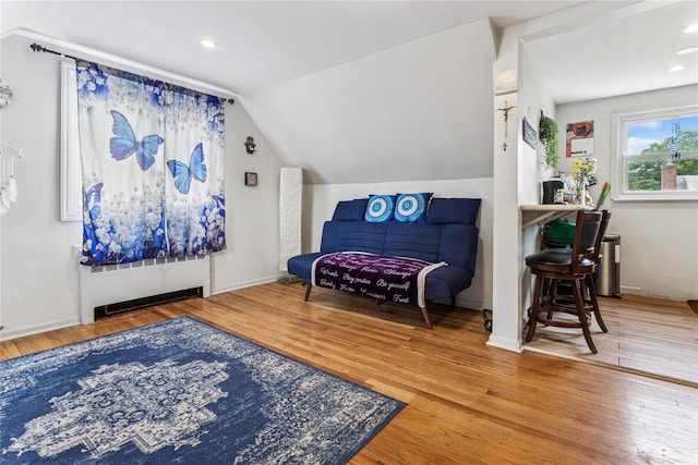 1343 E St, Elmont, NY 11003 - living area featuring wood finished floors, vaulted ceiling, baseboards, and recessed lighting