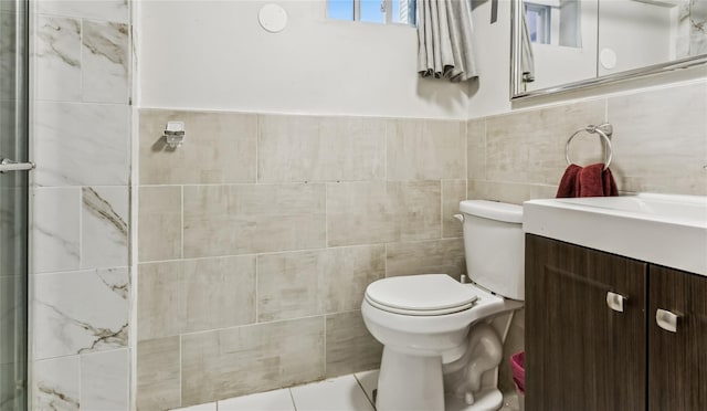 1343 E St, Elmont, NY 11003 - full bathroom featuring tile walls, vanity, toilet, and a tile shower