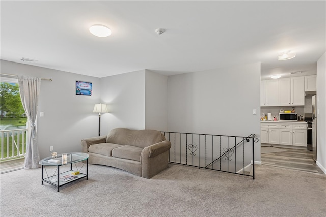 241 Fairview Cir, Middle Island, NY 11953 - living area featuring light colored carpet and baseboards