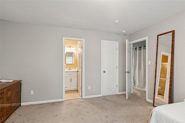 241 Fairview Cir, Middle Island, NY 11953 - bedroom featuring light carpet, a sink, baseboards, and connected bathroom