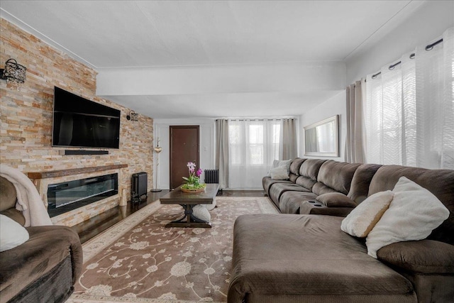 23 Bonta St, Elmont, NY 11003 - living area with a glass covered fireplace, beam ceiling, and radiator