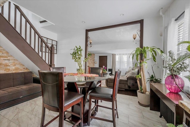 23 Bonta St, Elmont, NY 11003 - dining space featuring plenty of natural light, stairs, and light marble finish floors