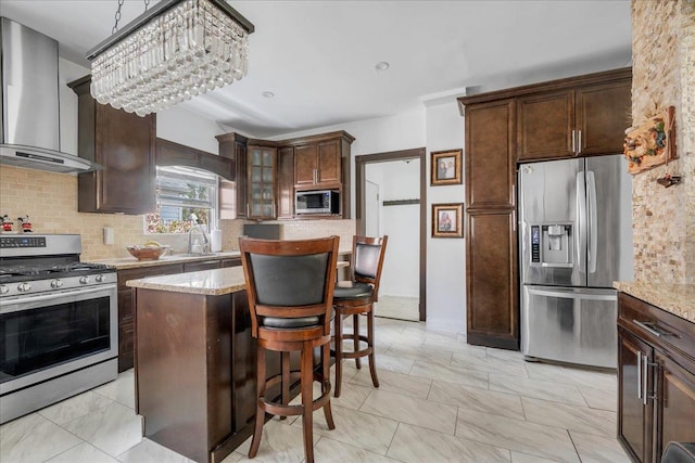 23 Bonta St, Elmont, NY 11003 - kitchen featuring appliances with stainless steel finishes, wall chimney exhaust hood, tasteful backsplash, and a sink