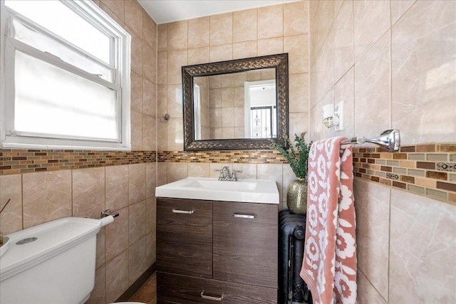 23 Bonta St, Elmont, NY 11003 - bathroom featuring tile walls, vanity, healthy amount of natural light, and toilet