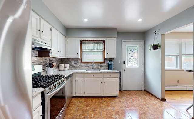 285 Riley Rd, New Windsor, NY 12553 - kitchen featuring stainless steel appliances, a sink, under cabinet range hood, backsplash, and white cabinets