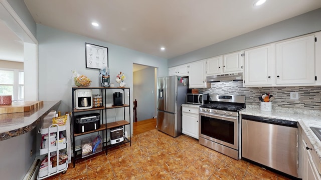 285 Riley Rd, New Windsor, NY 12553 - kitchen featuring appliances with stainless steel finishes, under cabinet range hood, decorative backsplash, white cabinetry, and recessed lighting