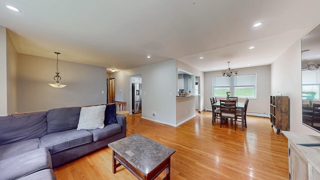 285 Riley Rd, New Windsor, NY 12553 - living room featuring light wood finished floors, recessed lighting, a chandelier, a baseboard radiator, and baseboards