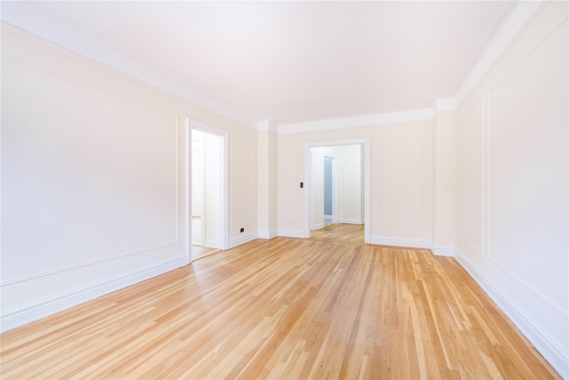 19 William St Unit 3G, Mount Vernon, NY 10552 - spare room featuring light wood-style floors, a decorative wall, and crown molding