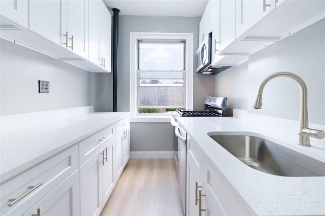 19 William St Unit 3G, Mount Vernon, NY 10552 - kitchen featuring healthy amount of natural light, stainless steel appliances, white cabinetry, and light wood-type flooring