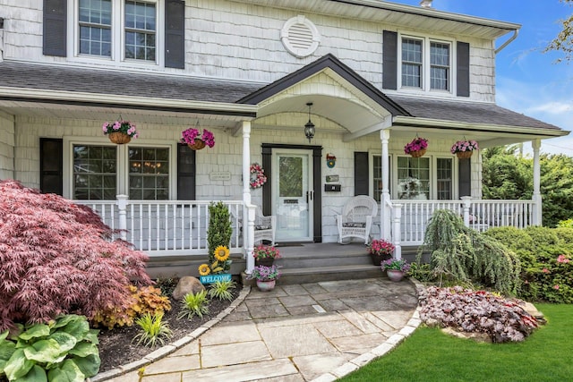 28 Bradford Rd, Plainview, NY 11803 - doorway to property featuring a porch and a shingled roof