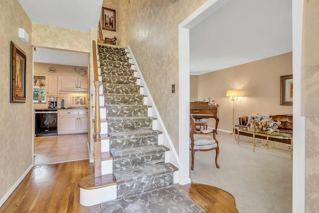 28 Bradford Rd, Plainview, NY 11803 - stairway featuring baseboards, wallpapered walls, and wood finished floors