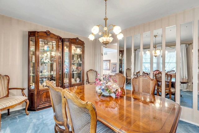 28 Bradford Rd, Plainview, NY 11803 - carpeted dining area with a chandelier and baseboards