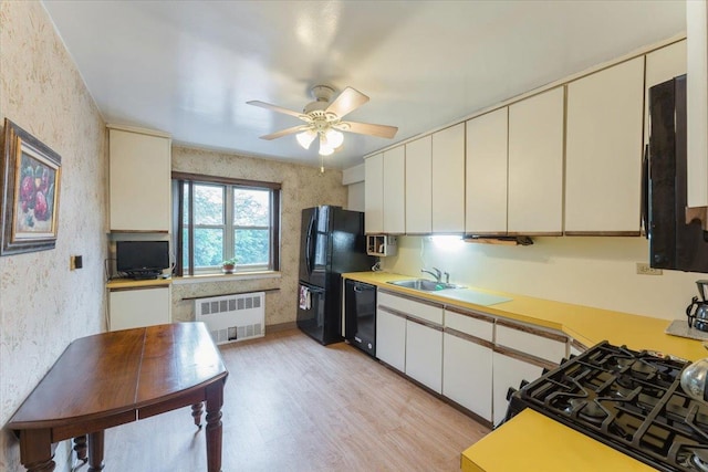 31-90 140th St Unit 3K, Flushing, NY 11354 - kitchen featuring radiator heating unit, black appliances, light wood-type flooring, light countertops, and a sink