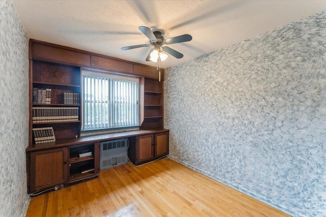 31-90 140th St Unit 3K, Flushing, NY 11354 - unfurnished office with radiator, light wood-style flooring, ceiling fan, wallpapered walls, and a textured ceiling