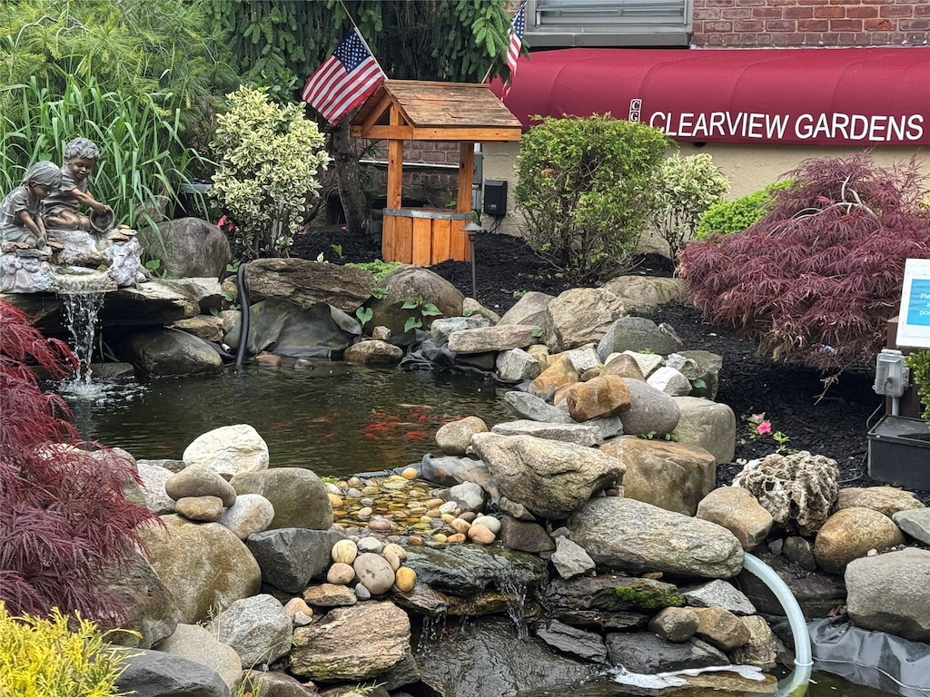 199-07 21st Ave Unit 1-361, Whitestone, NY 11357 - view of yard with a small pond