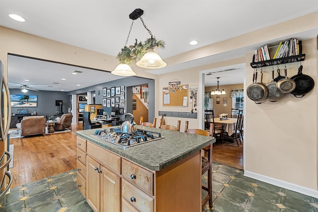 21 Mile Rd, Suffern, NY 10901 - kitchen with light brown cabinetry, a kitchen breakfast bar, a kitchen island, stainless steel gas cooktop, and ceiling fan