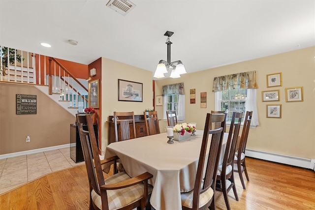 21 Mile Rd, Suffern, NY 10901 - dining space featuring a baseboard radiator, stairs, a chandelier, and light wood-style floors