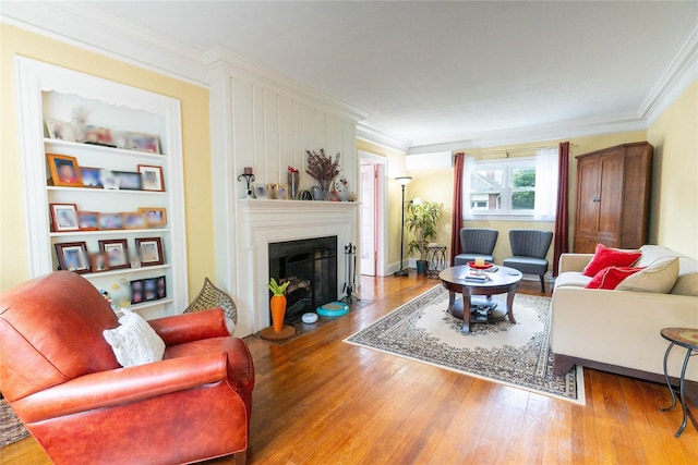 42-32 204th St, Bayside, NY 11361 - living room featuring wood finished floors, ornamental molding, a fireplace with flush hearth, and a wall mounted air conditioner