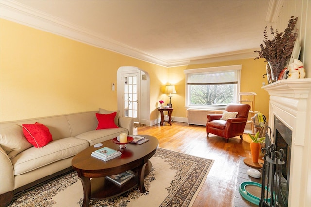 42-32 204th St, Bayside, NY 11361 - living room with arched walkways, ornamental molding, wood finished floors, and a fireplace